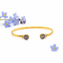 Bracciale rigido in ottone regolabile con fiore di non ti scordar di me