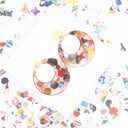 Orecchini a cerchio con coriandoli