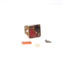 An adjustable brass ring with natural marine materials and plastic