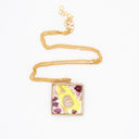 Necklace with resin pendant featuring natural and polluting marine elements