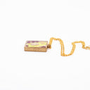 Necklace with resin pendant featuring natural and polluting marine elements