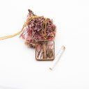 Resin pendant necklace with natural and polluting marine elements