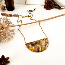 Load image into Gallery viewer, Half moon necklace with pendant with flower cutouts and gold fragments
