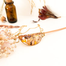 Load image into Gallery viewer, Half moon necklace with pendant with flower cutouts and gold fragments
