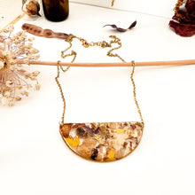 Load image into Gallery viewer, Half moon necklace with pendant with flower cutouts and gold fragments
