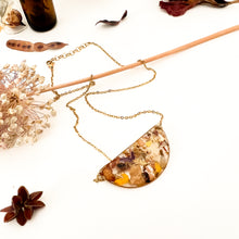 Load image into Gallery viewer, Half moon necklace with pendant with flower cutouts and gold fragments
